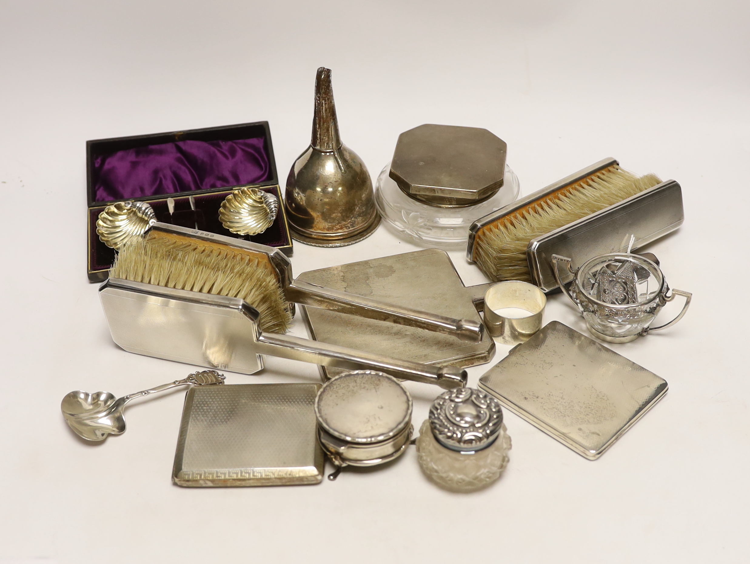 A group of assorted small silver, including a powder jar, trinket box, cigarette case, mirror and brush set etc. and a plated wine funnel.